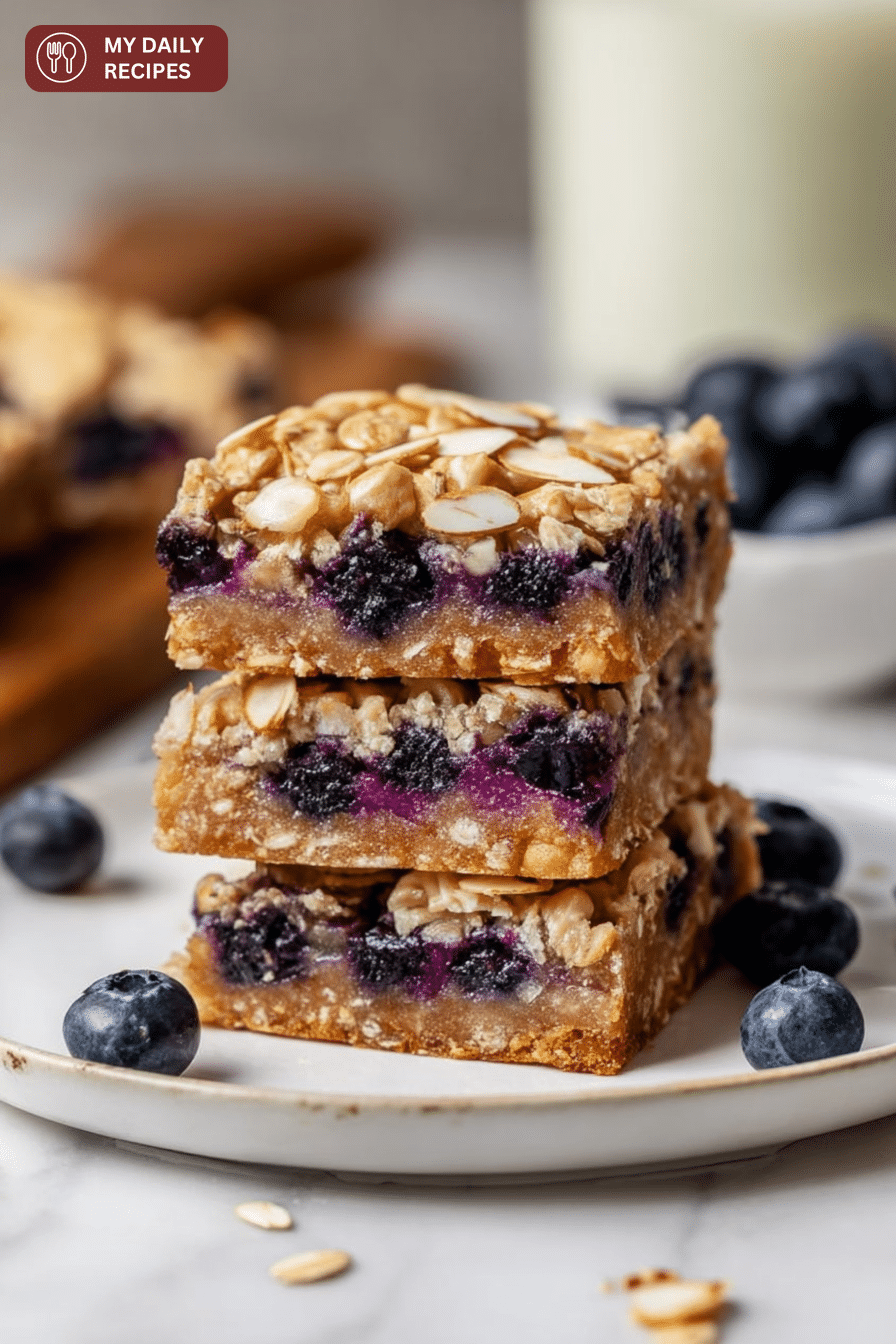 Delicious blueberry oatmeal bars sliced and served with fresh blueberries and honey drizzle