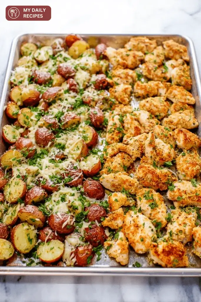 Close-up of baked garlic parmesan chicken and roasted red potatoes, garnished with parsley.