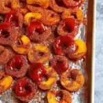 Close-up of chamoy peach rings coated in Tajín on a wooden table
