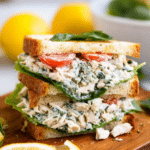 Bowl of easy lemon basil chicken salad with fresh herbs and crackers