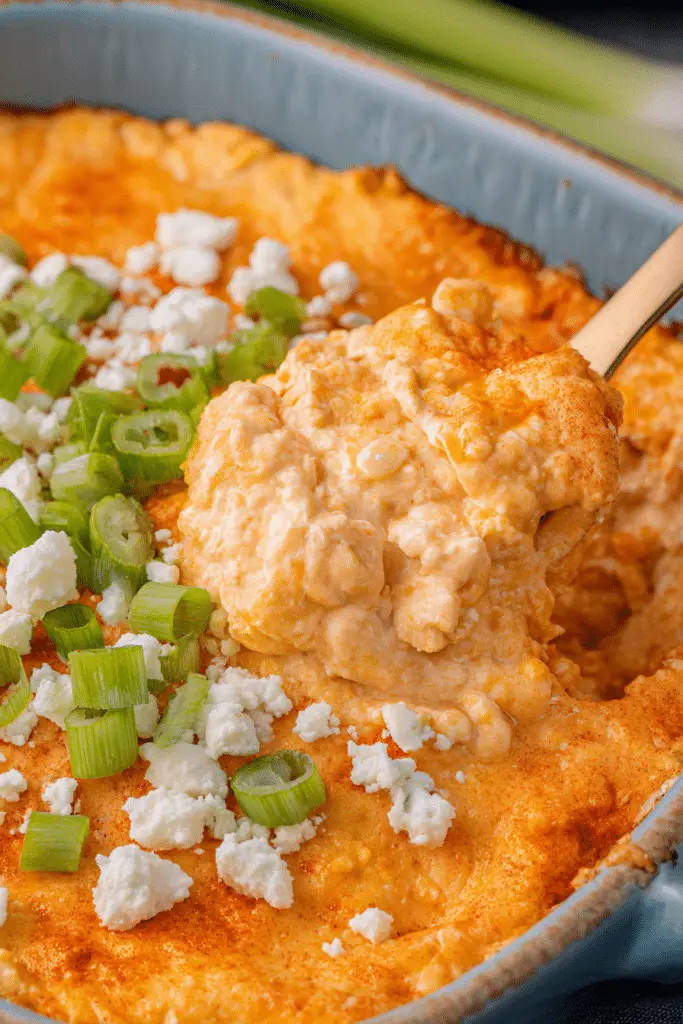 Delicious Frank's RedHot Buffalo Chicken Dip garnished with green onions, surrounded by tortilla chips.