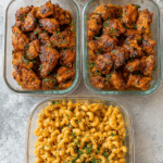 High-protein honey garlic butter chicken served with creamy mac and cheese, garnished with fresh parsley.