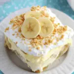 Delicious No Bake Banana Pudding Dessert with layers of vanilla pudding, sliced bananas, and crushed wafer cookies.
