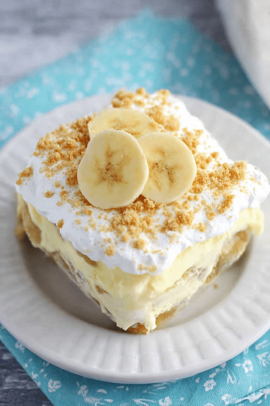 Delicious No Bake Banana Pudding Dessert with layers of vanilla pudding, sliced bananas, and crushed wafer cookies.