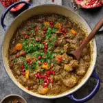 Delicious Persian lamb stew served with herbs and pomegranate, accompanied by basmati rice.