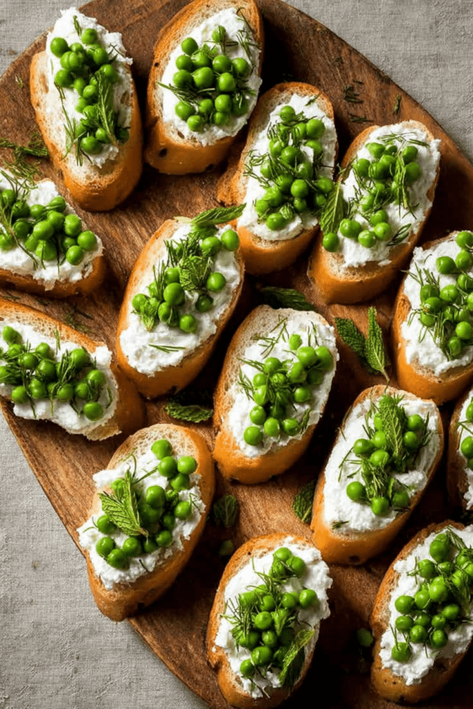 Ricotta crostini with peas and mint served on a wooden platter, showcasing the fresh ingredients and spring flavors.