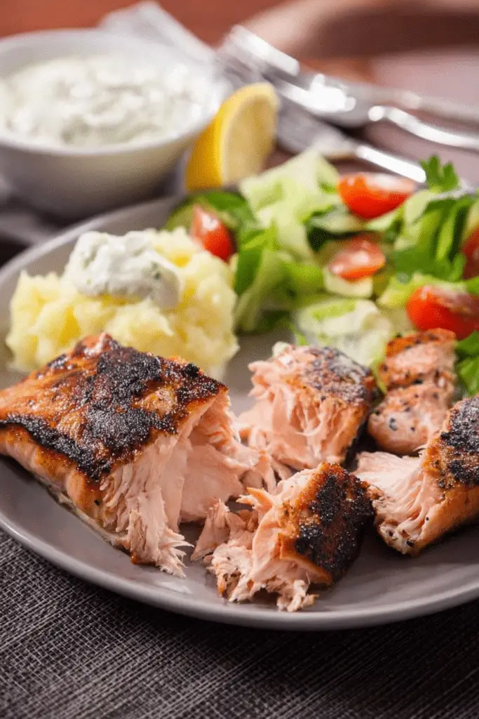 Plated Texas Roadhouse salmon with lemon and herbs on a rustic table
