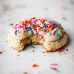 Close-up of soft and colorful birthday cake cookies topped with sprinkles.