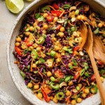 Chopped Thai-inspired chickpea salad with colorful vegetables and curry peanut dressing