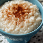 Close-up of creamy rice pudding in a bowl with cinnamon sprinkle on top