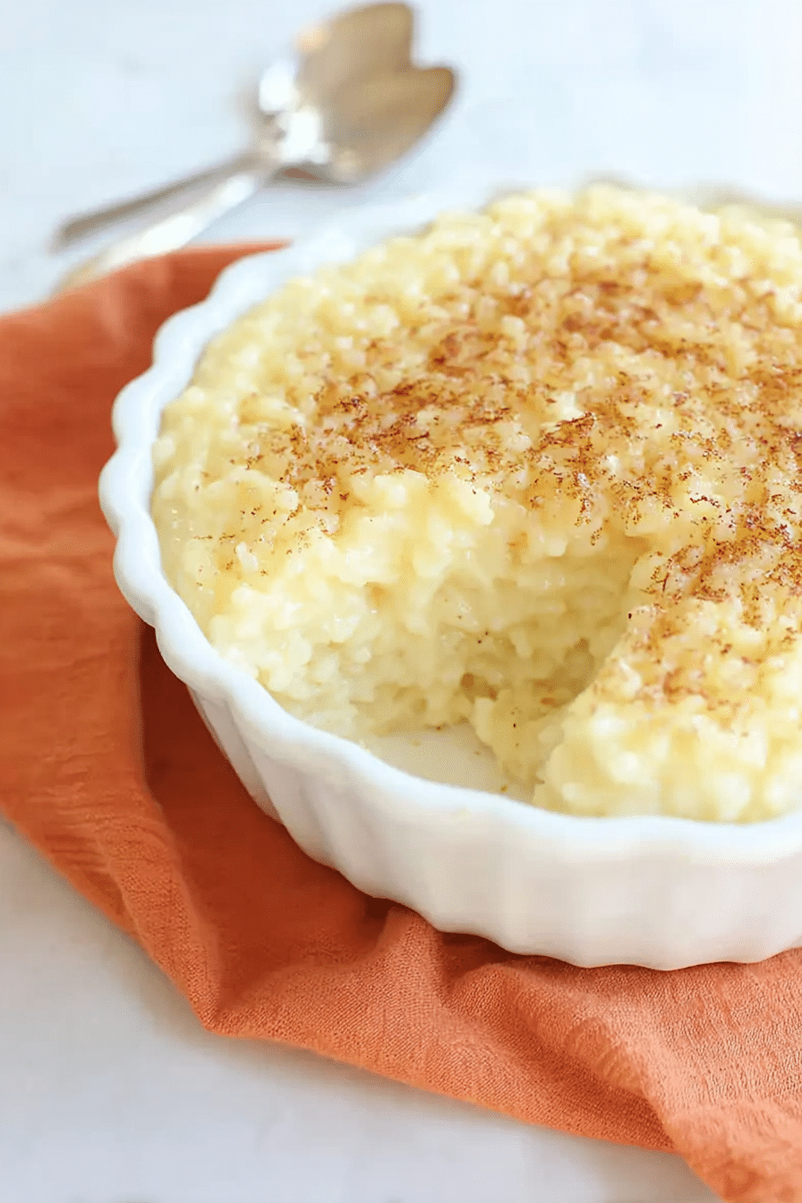 Homemade Portuguese sweet rice pudding (Arroz Doce) topped with cinnamon and lemon zest.