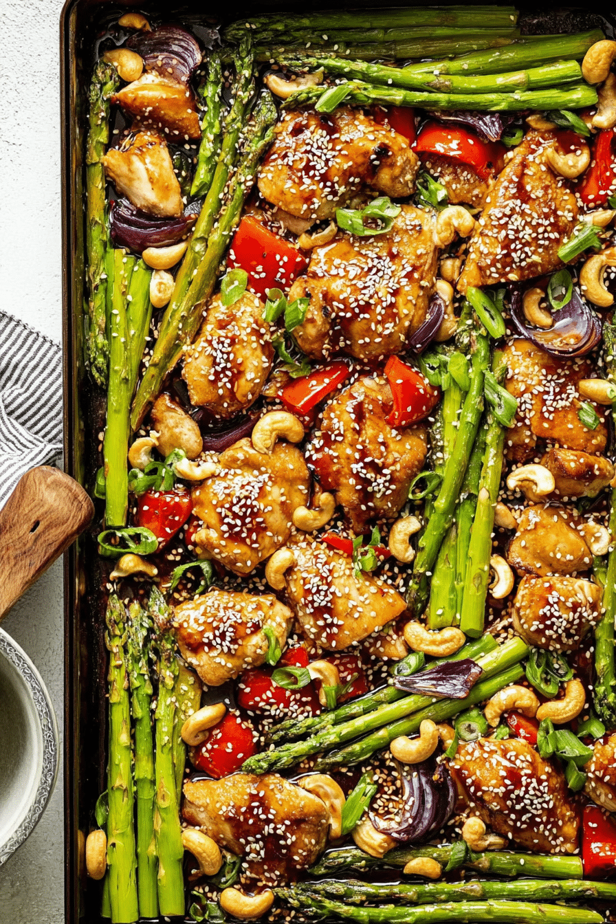 Sheet pan sesame chicken with vibrant vegetables and fresh herbs, perfect for a weeknight dinner.