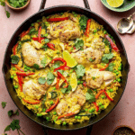 Delicious Thai-inspired yellow curry chicken and rice topped with cilantro and lime, served in a colorful bowl.
