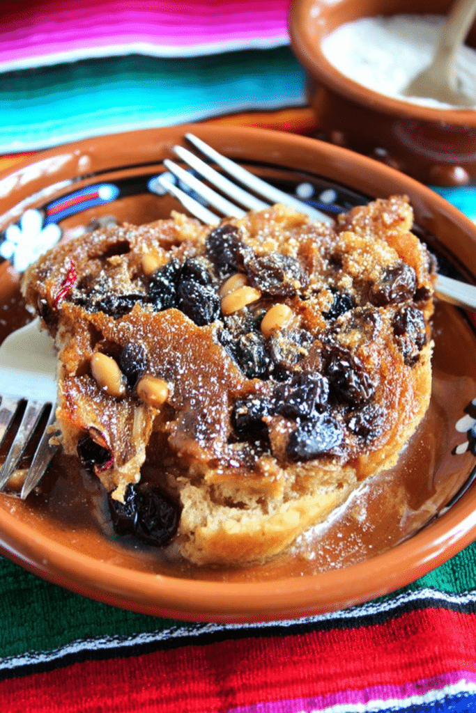 Delicious serving of traditional Mexican capirotada bread pudding topped with melted cheese, raisins, and nuts.
