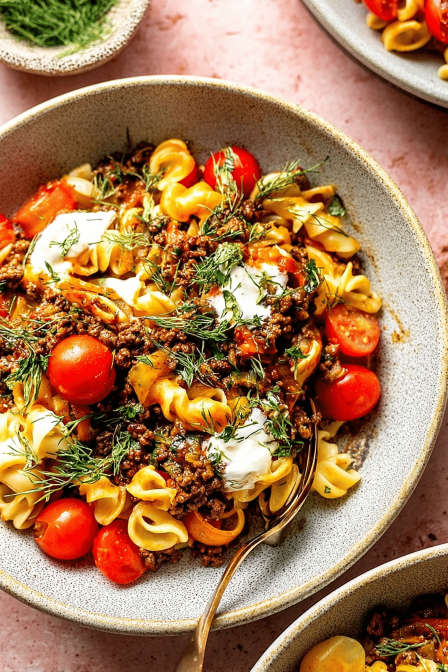 Vibrant bowl of viral Turkish pasta with creamy garlic yogurt and paprika butter drizzle.