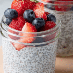 Delicious 3-ingredient chia pudding topped with fresh strawberries in a glass jar.