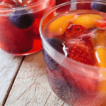 Vibrant agar agar fruit jelly with fresh fruits in a decorative bowl.