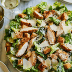 Best Chicken Caesar Salad with homemade croutons on a rustic wooden table, featuring grilled chicken, croutons, and fresh romaine.