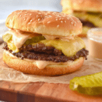 Close-up of a delicious homemade smash burger with melted cheese and fresh toppings