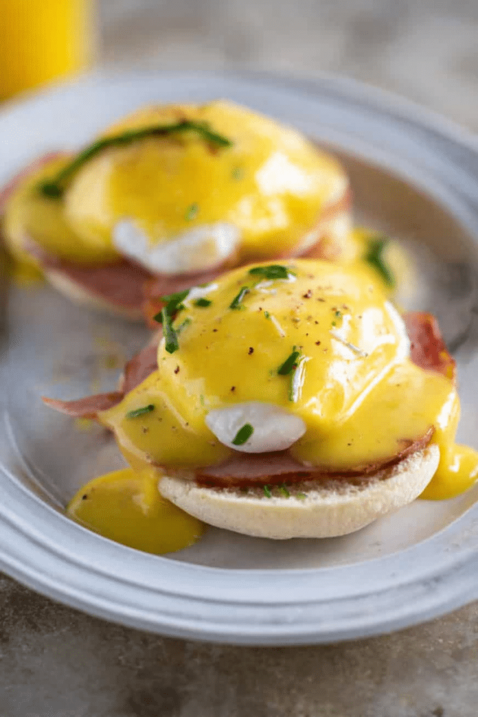 Delicious Eggs Benedict with poached egg, Canadian bacon, and homemade hollandaise sauce on a toasted English muffin.