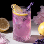 Refreshing lavender lemonade served in a highball glass with ice, garnished with a lemon wheel and lavender, perfect for spring.