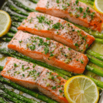 Delicious sheet pan salmon and asparagus with lemon slices and fresh herbs, perfect for an easy dinner recipe.