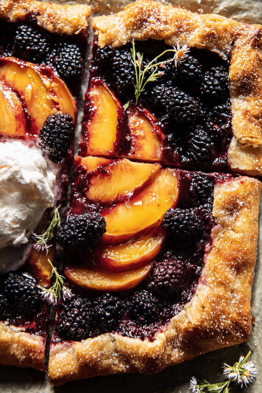 Delicious blackberry peach galette displayed on a wooden table, showcasing a golden crust and vibrant fruit filling.