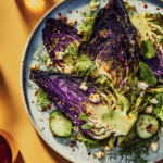Charred grilled cabbage wedges served with goat cheese raita and fresh herbs, styled for a summer dining experience.