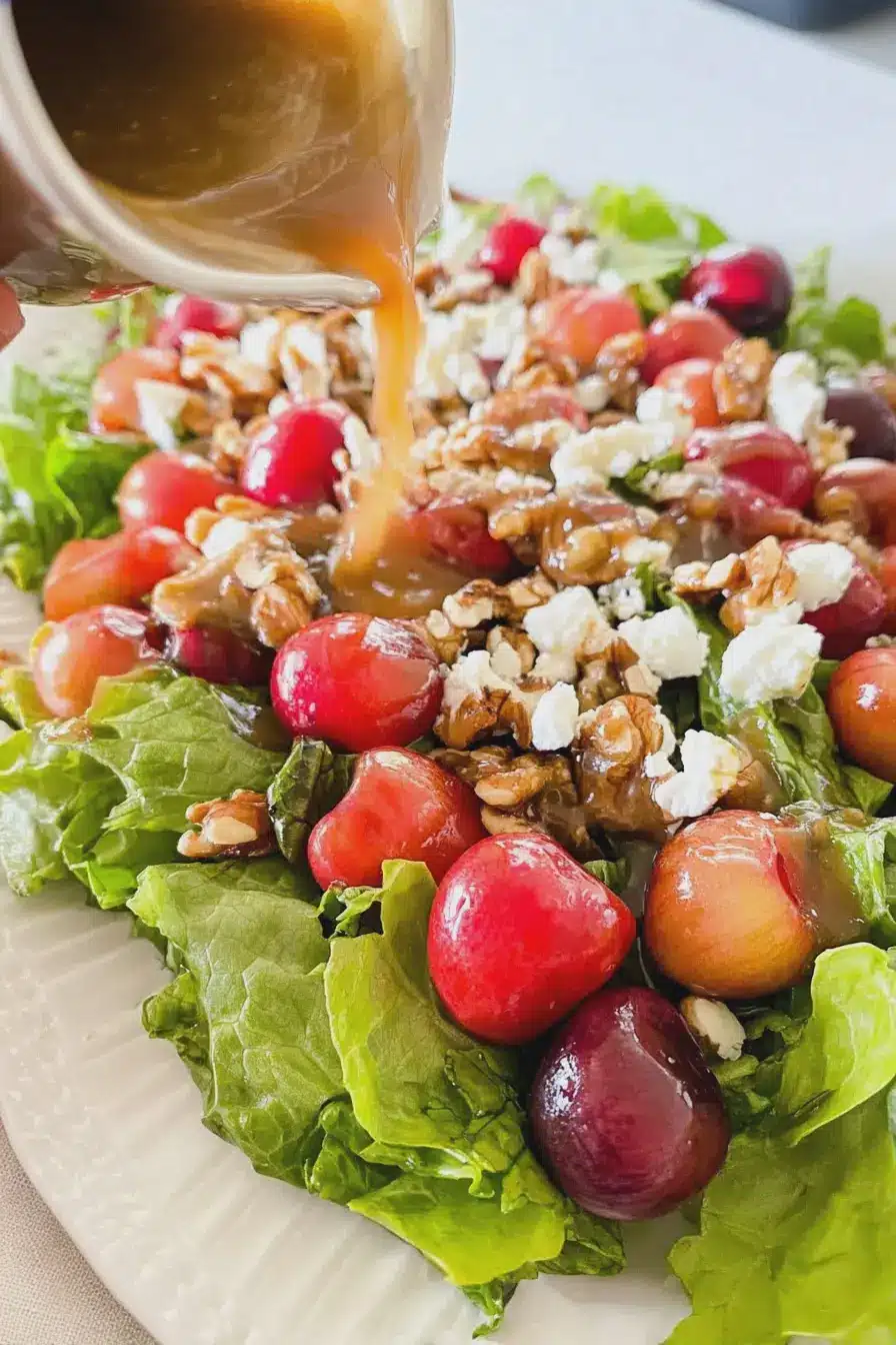 Close-up of cherry salad with feta and walnuts topped with balsamic vinaigrette.