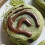 Chewy matcha mochi bites dusted with powdered sugar, served with a cup of green tea