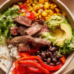 A colorful Chipotle Steak Fajita Bowl with grilled steak, sautéed peppers, and fresh guacamole.