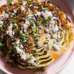 Close-up of air fryer cabbage tahini steaks garnished with pepita and sesame seeds.