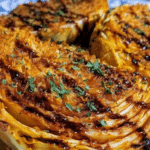 Crispy parmesan garlic cabbage steaks garnished with parsley and balsamic vinegar, showcasing a delicious and healthy side dish.
