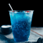 Refreshing Easy Sonic Ocean Water in a glass, garnished with cherries and ice, perfect for summer.