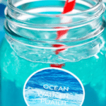 A refreshing Ocean Water Blue Punch in a large bowl with paper straws, ideal for summer gatherings.