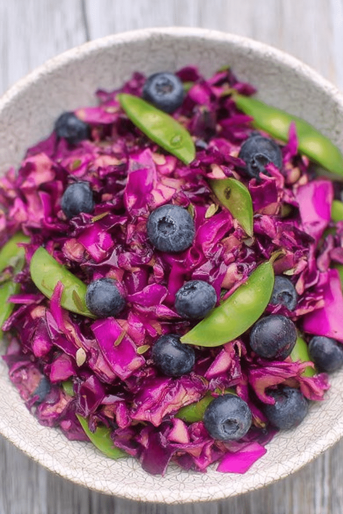 Vibrant red cabbage blueberry salad with snap peas and lemon dressing