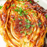Close-up of roasted cabbage with miso butter, showing caramelized edges and rich colors.