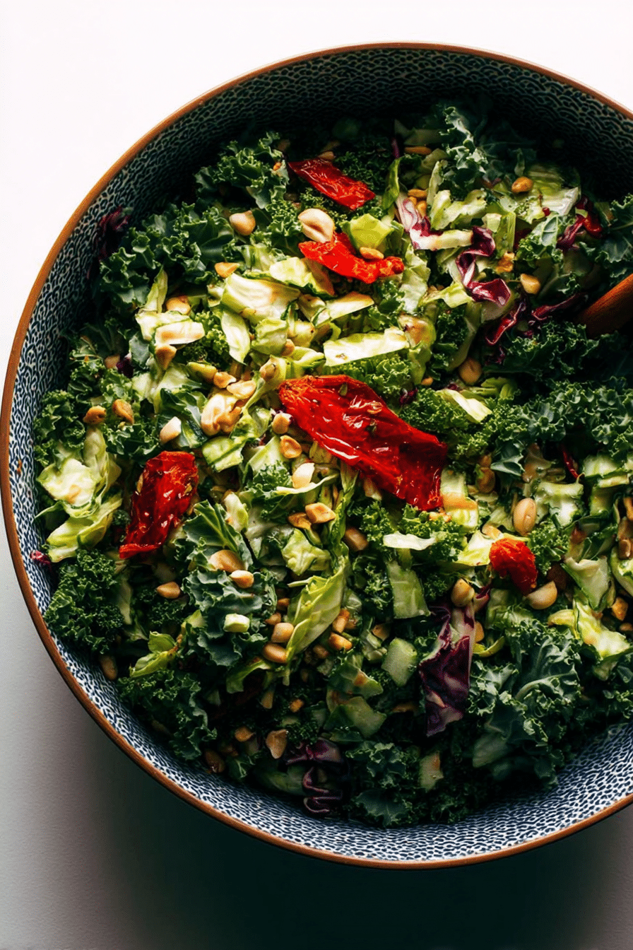 Roasted peanut kale crunch salad with vibrant kale, cabbage, peanuts, and fresno peppers in a bowl.