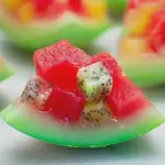 Watermelon fruit jelly served in a hollowed watermelon half with assorted fruits.